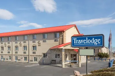 a hotel with a sign in front of a building at Travelodge by Wyndham Loveland/Fort Collins Area in Loveland