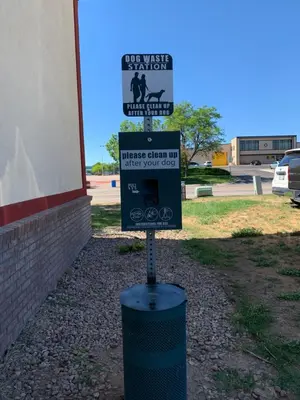 a street sign on a pole in front of a building at Super 8 by Wyndham Greeley in Greeley