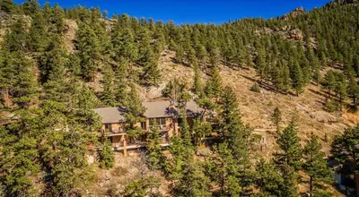 an aerial view of a house on a mountain at The Cedars Luxury Home At Windcliff Home in Estes Park