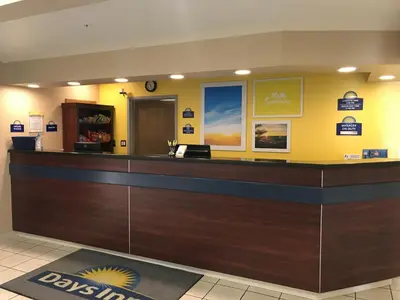 a cashier counter in a dental office with yellow walls at Days Inn & Suites by Wyndham Greeley in Greeley