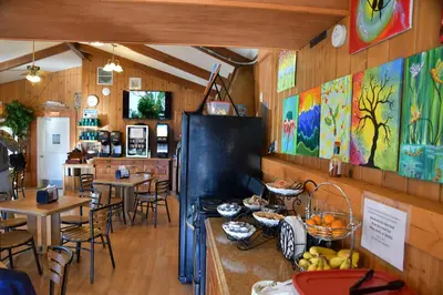 a restaurant with tables and chairs and a counter with food at Murphy's Resort in Estes Park