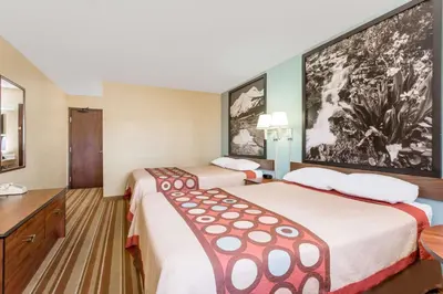 a hotel room with two beds and a desk at Super 8 by Wyndham Dillon/Breckenridge Area in Dillon