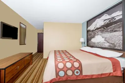a hotel room with a bed and a flat screen tv at Super 8 by Wyndham Dillon/Breckenridge Area in Dillon