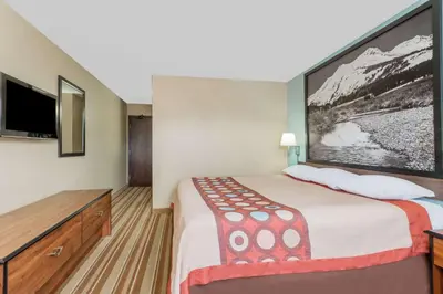 a hotel room with a large bed and a flat screen tv at Super 8 by Wyndham Dillon/Breckenridge Area in Dillon