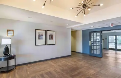 a living room with a ceiling fan and wood floors at Extended Stay America Select Suites - Denver - Tech Center South - Greenwood Village in Centennial