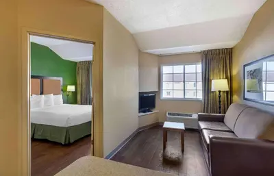 a hotel room with a bed and a couch at Extended Stay America Select Suites - Denver - Tech Center South - Greenwood Village in Centennial