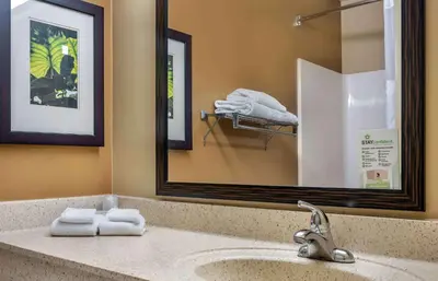 a bathroom with a sink with a mirror and towels at Extended Stay America Select Suites - Denver - Tech Center South - Greenwood Village in Centennial