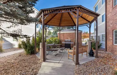 a wooden gazebo with a table and bench at Extended Stay America Select Suites - Denver - Tech Center South - Greenwood Village in Centennial