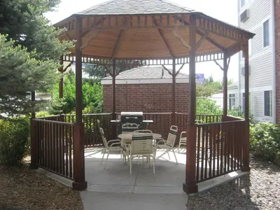 a wooden gazebo with a table and chairs at Extended Stay America Select Suites - Denver - Tech Center South - Greenwood Village in Centennial