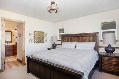 a bedroom with a large bed and a bathroom at Hawkeye Ridge in Estes Park