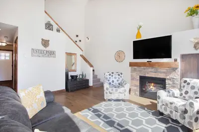 a living room with two couches and a fireplace at Hawkeye Ridge in Estes Park