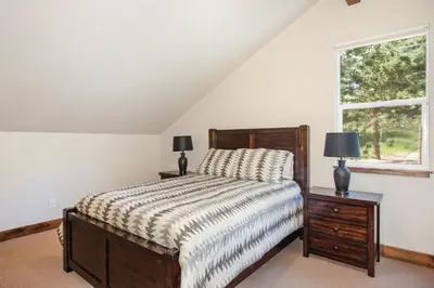 a bedroom with a bed and a window at Hawkeye Ridge in Estes Park
