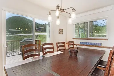 a dining room with a wooden table and chairs at Hawkeye Ridge in Estes Park