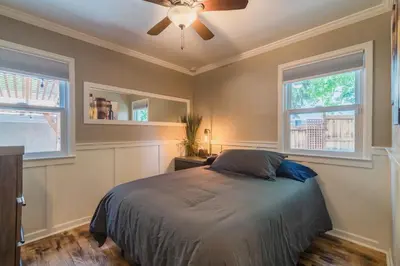 a bedroom with a bed and two windows at Italian Style in Old Town with Private Hot Tub in Fort Collins