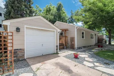 a house with a garage and a fence at Italian Style in Old Town with Private Hot Tub in Fort Collins