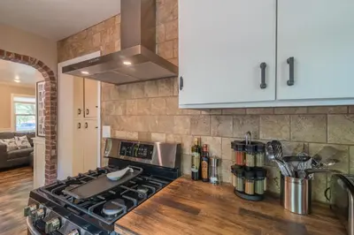 a kitchen with a stove and a counter top at Italian Style in Old Town with Private Hot Tub in Fort Collins