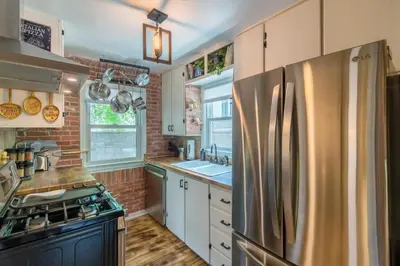 a kitchen with a stainless steel refrigerator at Italian Style in Old Town with Private Hot Tub in Fort Collins