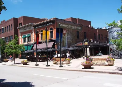 a street in a city with benches and buildings at Italian Style in Old Town with Private Hot Tub in Fort Collins