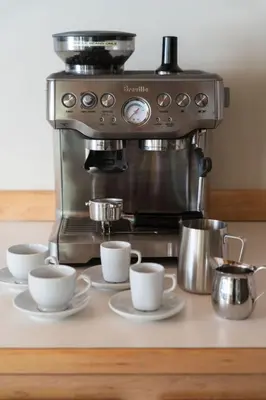 a coffee machine with three cups on a counter at Nederland Getaway Home in Nederland
