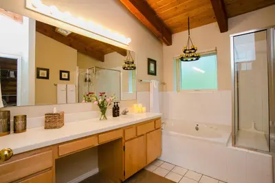 a bathroom with a sink and a tub and a shower at Nederland Getaway Home in Nederland