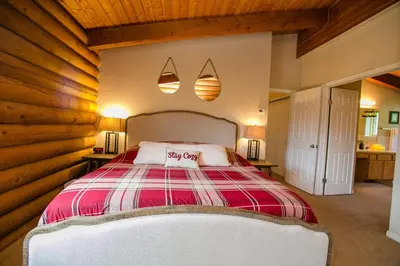 a bedroom with a bed with a red and white blanket at Nederland Getaway Home in Nederland