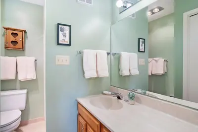 a bathroom with a sink and a toilet and a mirror at Deering Crest in Estes Park