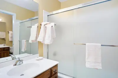 a bathroom with a shower and a sink and a mirror at Deering Crest in Estes Park