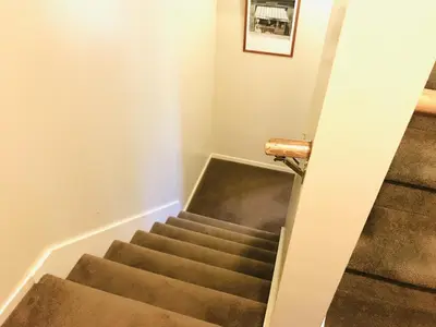a staircase in a house with brown carpet at Deering Crest in Estes Park