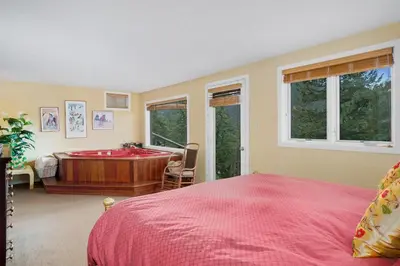 a bedroom with a bed and a tub in it at Deering Crest in Estes Park