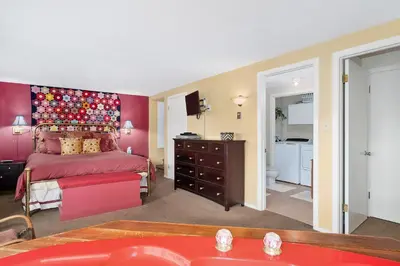 a bedroom with a bed and a red wall at Deering Crest in Estes Park