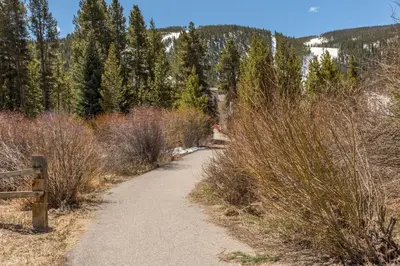 a dirt trail with a fence on the side at Aspen Glen 80 in Silverthorne