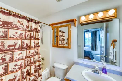 a bathroom with a toilet and a sink and a shower curtain at Aspen Glen 80 in Silverthorne