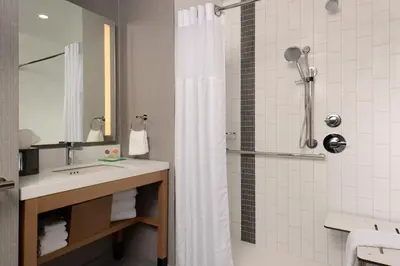 a bathroom with a sink and a shower with a shower curtain at Hyatt Place Pena Station/Denver Airport in Denver