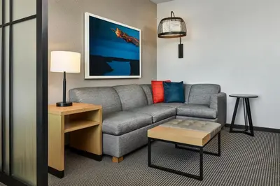 a living room with a couch and a table at Hyatt Place Pena Station/Denver Airport in Denver
