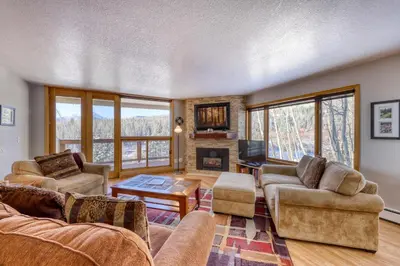 a living room with couches and a fireplace at Watch Hill 216 in Silverthorne