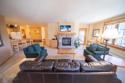 a living room with a couch and a fireplace at Dakota Lodge 8518 by SummitCove Lodging in Keystone