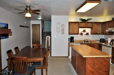 a kitchen with a wooden table and a dining room at Buffalo Ridge 2 Bedrooms 1 Loft BRBF in Silverthorne