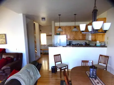 a living room and kitchen with a table and chairs at Anemone Townhome 3 bed 3 bath HTAT in Silverthorne