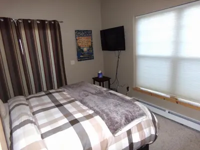 a bedroom with a bed and a flat screen tv at Anemone Townhome 3 bed 3 bath HTAT in Silverthorne