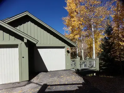 a garage with a white door and a fence at Anemone Townhome 3 bed 3 bath HTAT in Silverthorne