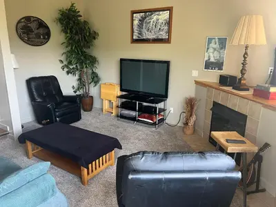 a living room with a tv and a couch and a fireplace at Forest Park 3 bed 4 Bath Twnhm HTJM in Silverthorne