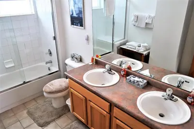 a bathroom with two sinks and a shower and a toilet at Forest Park 3 bed 4 Bath Twnhm HTJM in Silverthorne