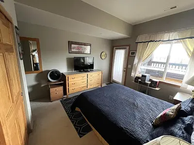 a bedroom with a bed and a television and a window at Forest Park 3 bed 4 Bath Twnhm HTJM in Silverthorne