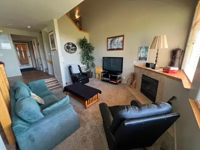 a living room with a blue couch and a television at Forest Park 3 bed 4 Bath Twnhm HTJM in Silverthorne