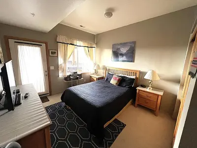 a small bedroom with a bed and a window at Forest Park 3 bed 4 Bath Twnhm HTJM in Silverthorne
