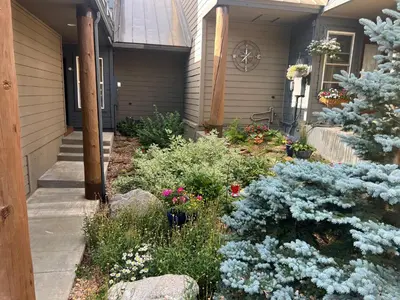 a house with blue flowers in the front yard at Forest Park 3 bed 4 Bath Twnhm HTJM in Silverthorne