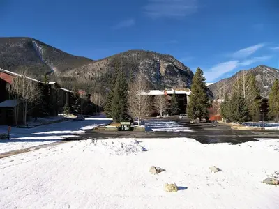 a snow covered parking lot with mountains in the background at Mountainside 2 Bed 2 Bath MSBD in Frisco