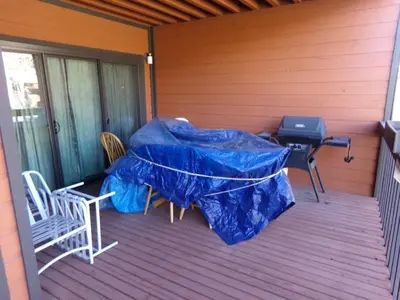 a screened porch with a grill and a table and chairs at Mountainside 2 Bed 2 Bath MSBD in Frisco