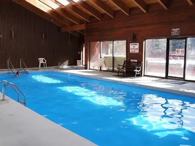 a large blue swimming pool in a building at Mountainside 2 Bed 2 Bath MSBD in Frisco