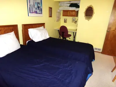 a bedroom with two beds with blue sheets and a desk at Mountainside 2 Bed 2 Bath MSBD in Frisco